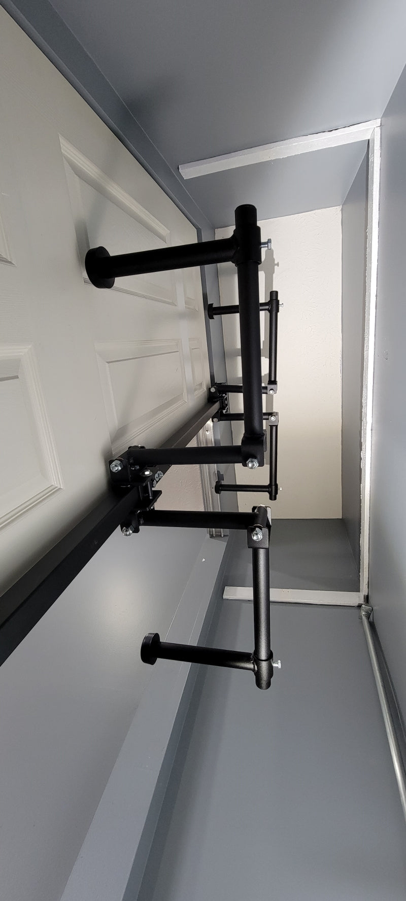Be Clever Closet Rod System in use, showing clothes hung perpendicularly and space for shelving behind, contrasting with traditional rods.