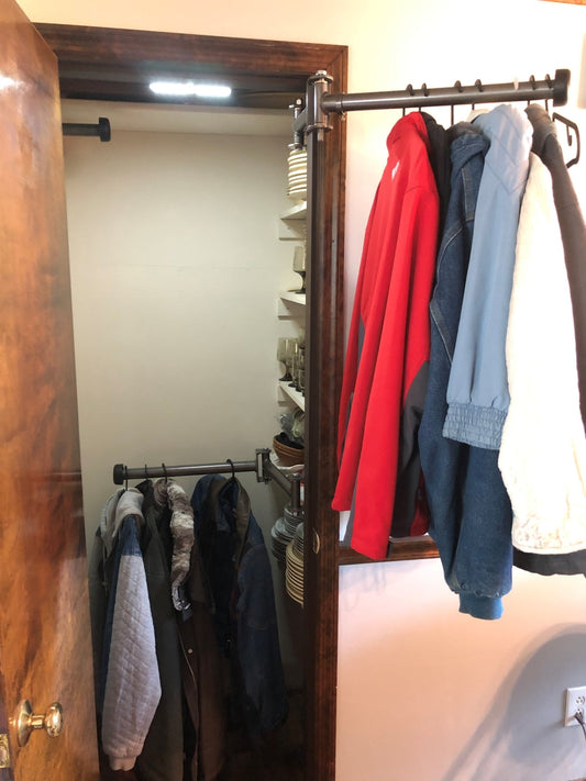 Image showing a cluttered closet transformed with Clever Closet Rods, displaying organized clothes, shoes, and shelves.
