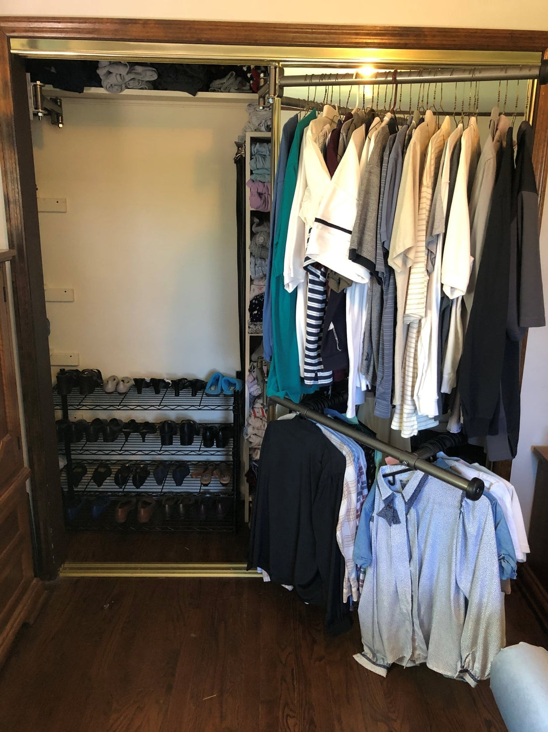 Be Clever Closet Rod System showing clothes on rotating rods in a small closet, highlighting space-saving design.